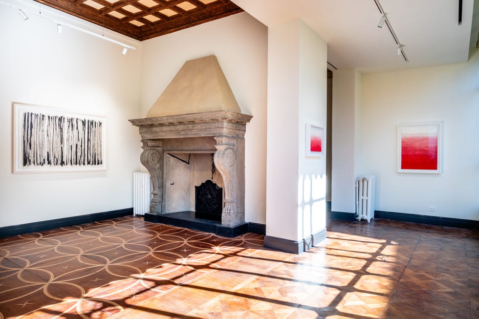 Modern interior space featuring artwork and a fireplace.