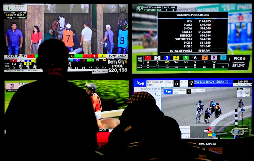 Bettors are watching televisions that are broadcasting live racing from racetracks across North America at Woodbine Racetrack in Toronto, Canada, on May 11, 2024. (Photo by Mike Campbell/NurPhoto via Getty Images)