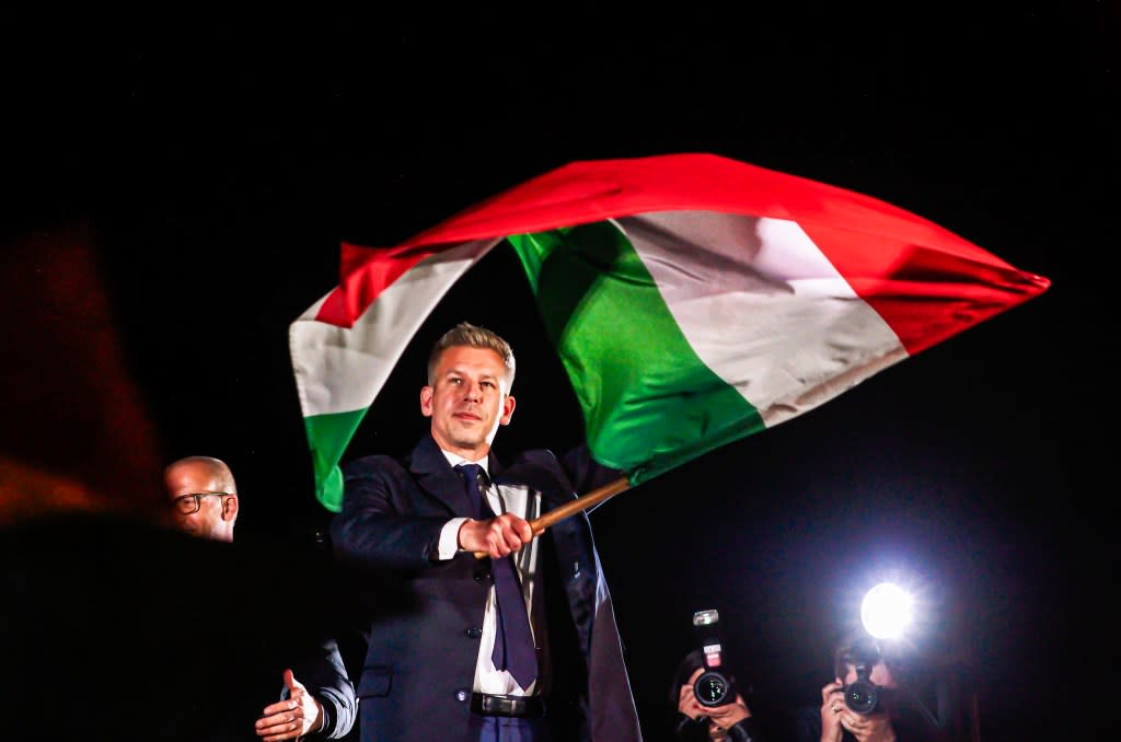 New Prime Minister of Hungary Peter Magyar waved a Hungarian flag after delivering his victory speech. Neil Milton / SOPA Images via Reuters Connect