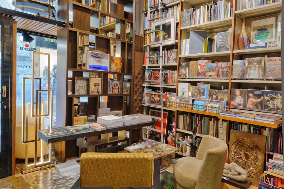 Bookstore interior with shelves of books and seating area.
