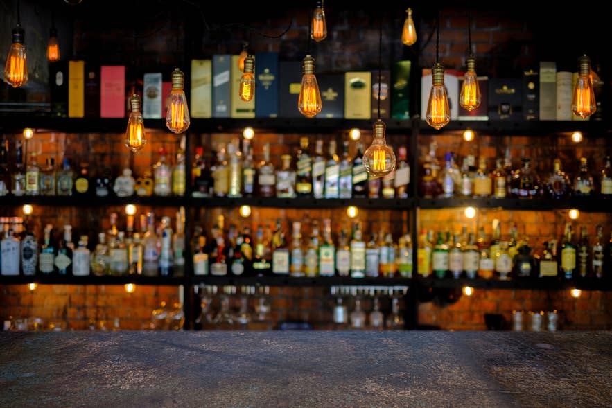 Steel table with soft focus Icelandic liquor bar background. Steel table with soft focus Icelandic liquor bar background.