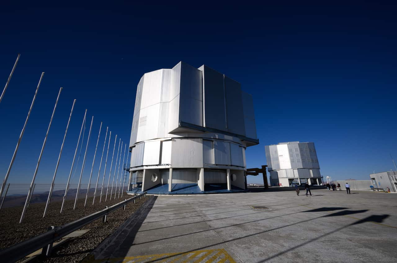 A large silver metal dome outside in a space observation facility.