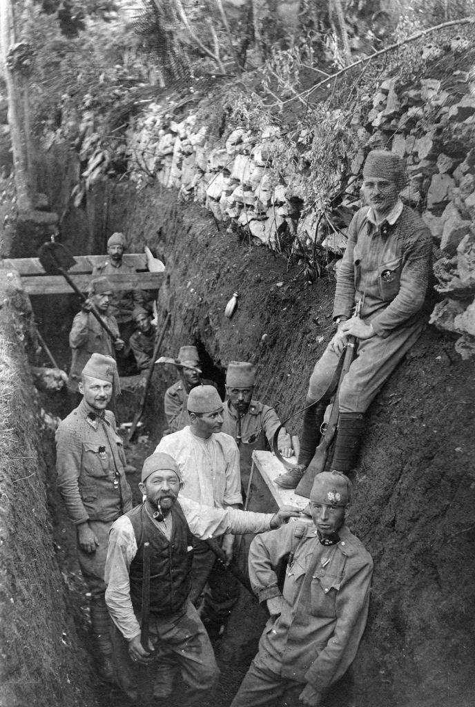 Bosnian soldiers posing to get their picture taken on the Eastern Front, 1915. One man can be seen helping dig the trench in the background.
