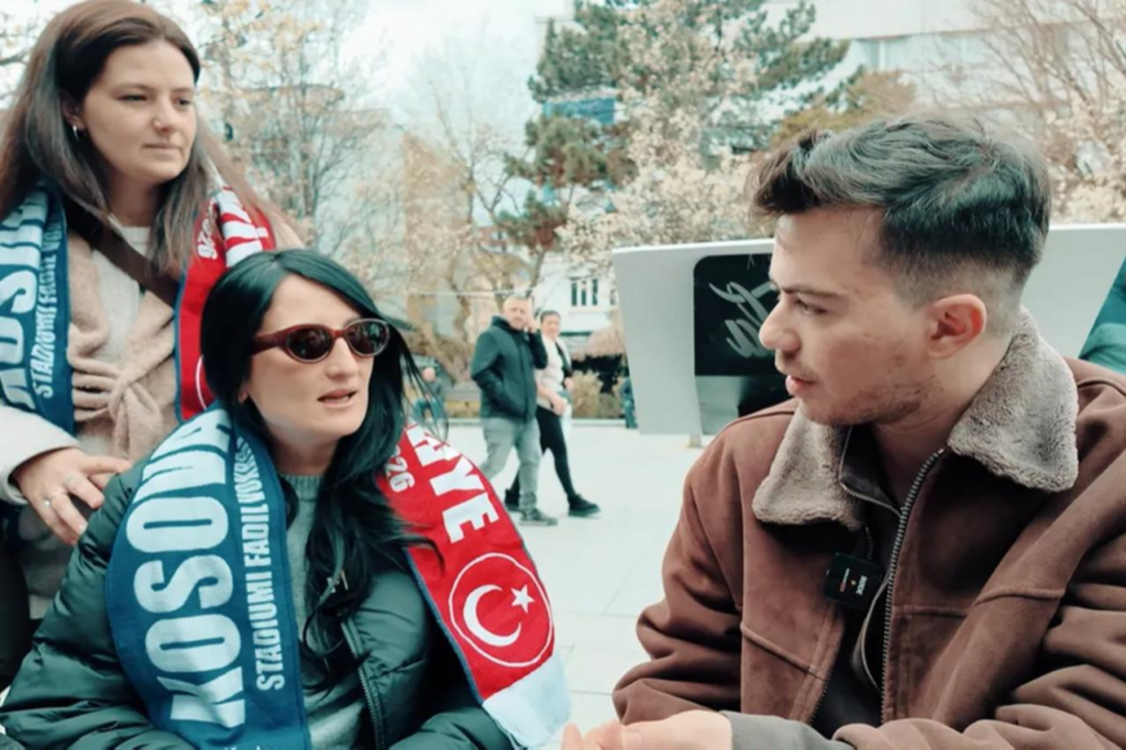 Dogukan Altas interviews locals on the streets of Kosovo during the documentary shoot. (Photo via FeedTalkz video)