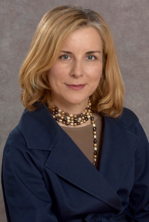 Maria Karayiorgou, MD, Professor Emerita of Psychiatry at Columbia University Medical Center, wearing a dark blue coat and a pearl necklace.