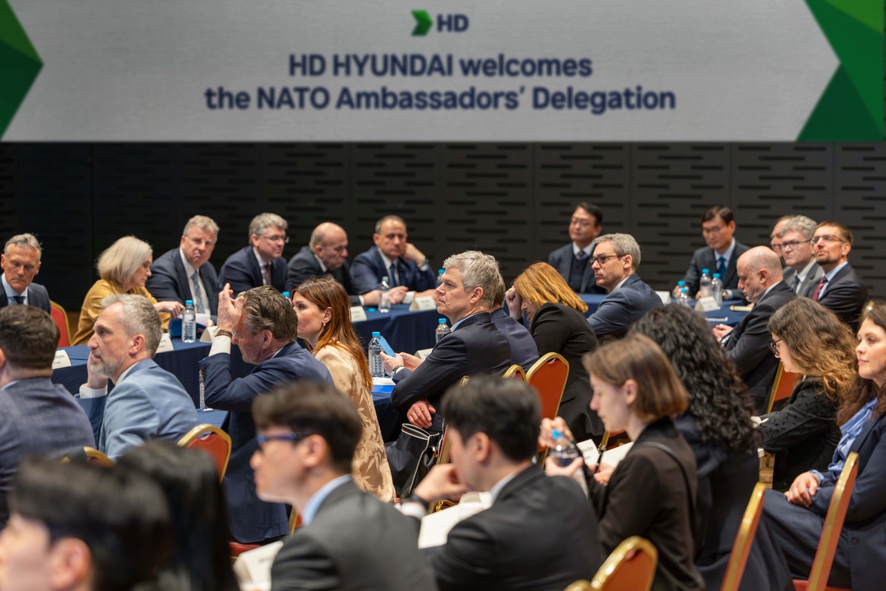 Ambassadors to NATO listen to a briefing from officials of HD Hyundai on the company’s vision and technological capabilities at Asan Hall in its Global R&D Center in Pangyo, Gyeonggi Province, Tuesday. (HD Hyundai)