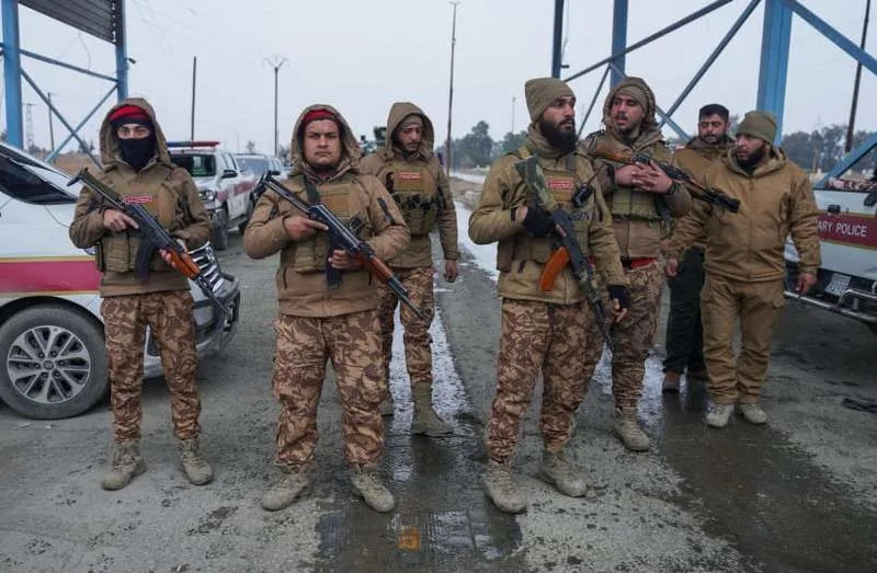 Members of the Syrian military police gather outside al-Aqtan prison, where some Islamic State detainees are held, in Raqqa, Syria January 22, 2026. (credit: REUTERS/KARAM AL-MASRI)