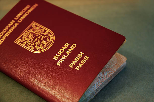 Close-up of a Finnish passport with gold lettering on a red cover