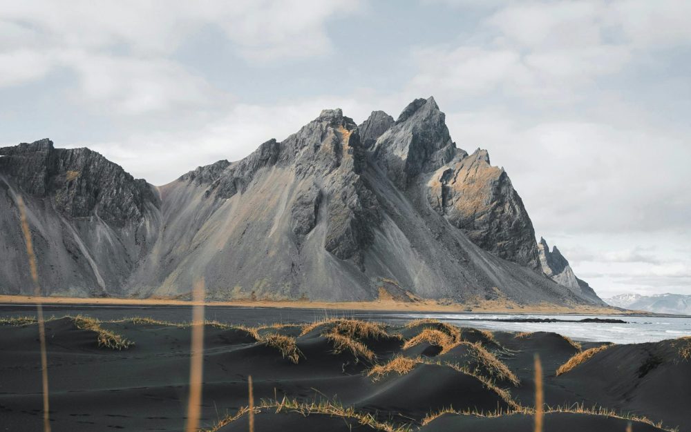 The Earth is full of marvels that inspire care for creation Mountains by shore in Iceland