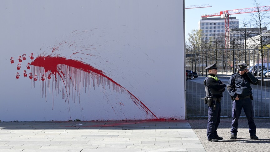 Activist throws red paint at Germany’s chancellery, denouncing support for Iran war logo