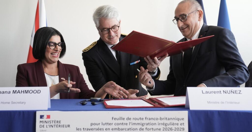 U.K. and French governments sign a 3-year deal to curb migrant crossings in English Channel