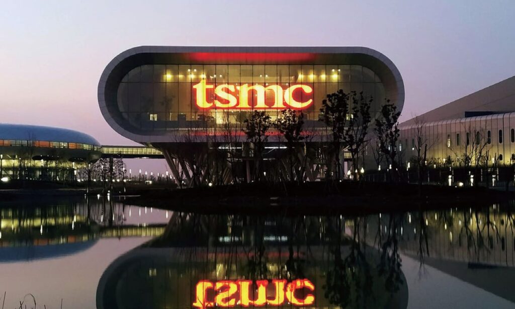 Prediction: The Best Pick-and-Shovel AI Stock of 2026 Won’t Be Nvidia or Broadcom TSMC logo displayed as a red neon sign on a company building.