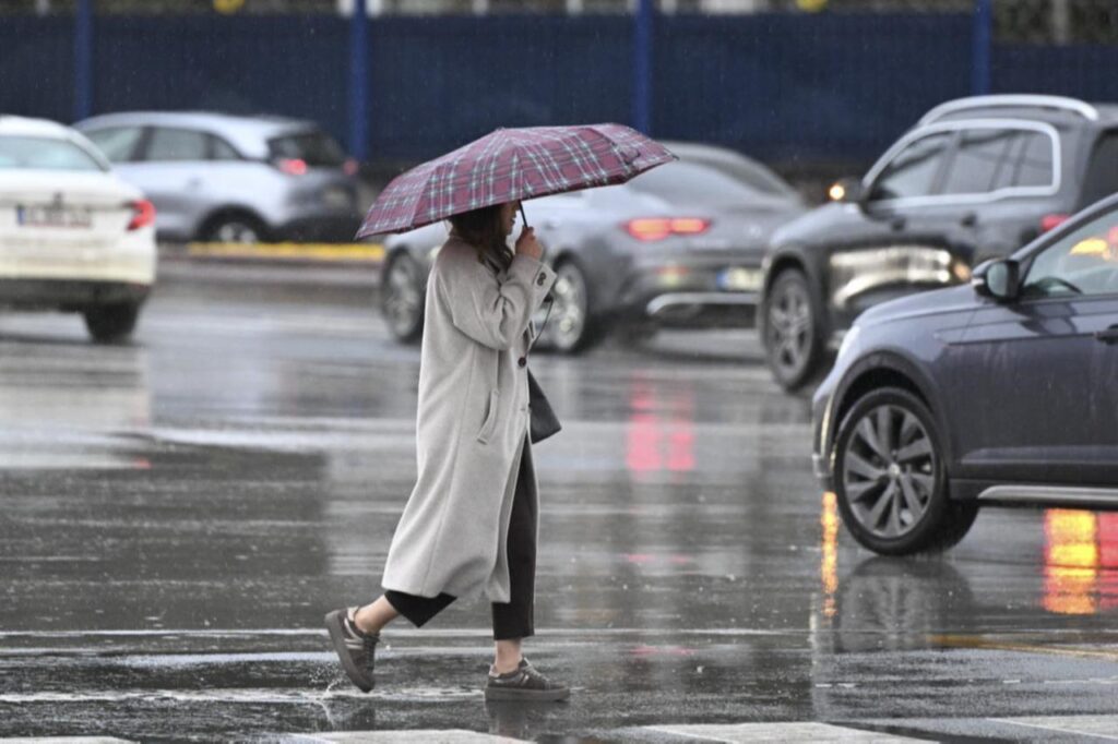 A woman uses an umbrella to protect herself from the rain. Ankara, Türkiye, February 13, 2026. (AA Photo)