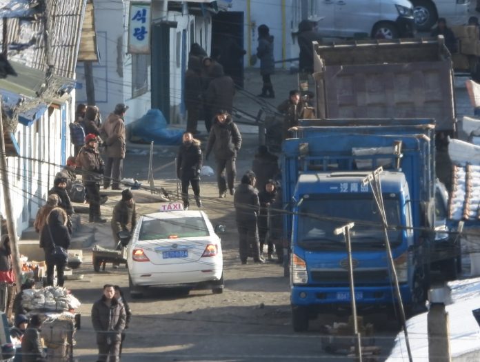 North Koreans sell goods on the street in the North Korea-China border region