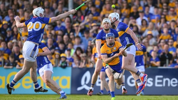 10 May 2025; Shane O Donnell of Clare passes the sliothar under pressure from Tipperary players including Peter McGarry during the Munster GAA Hurling Senior Championship Round 3 match between Clare and Tipperary at Zimmer Biomet Páirc Chíosóg in Ennis, Clare.