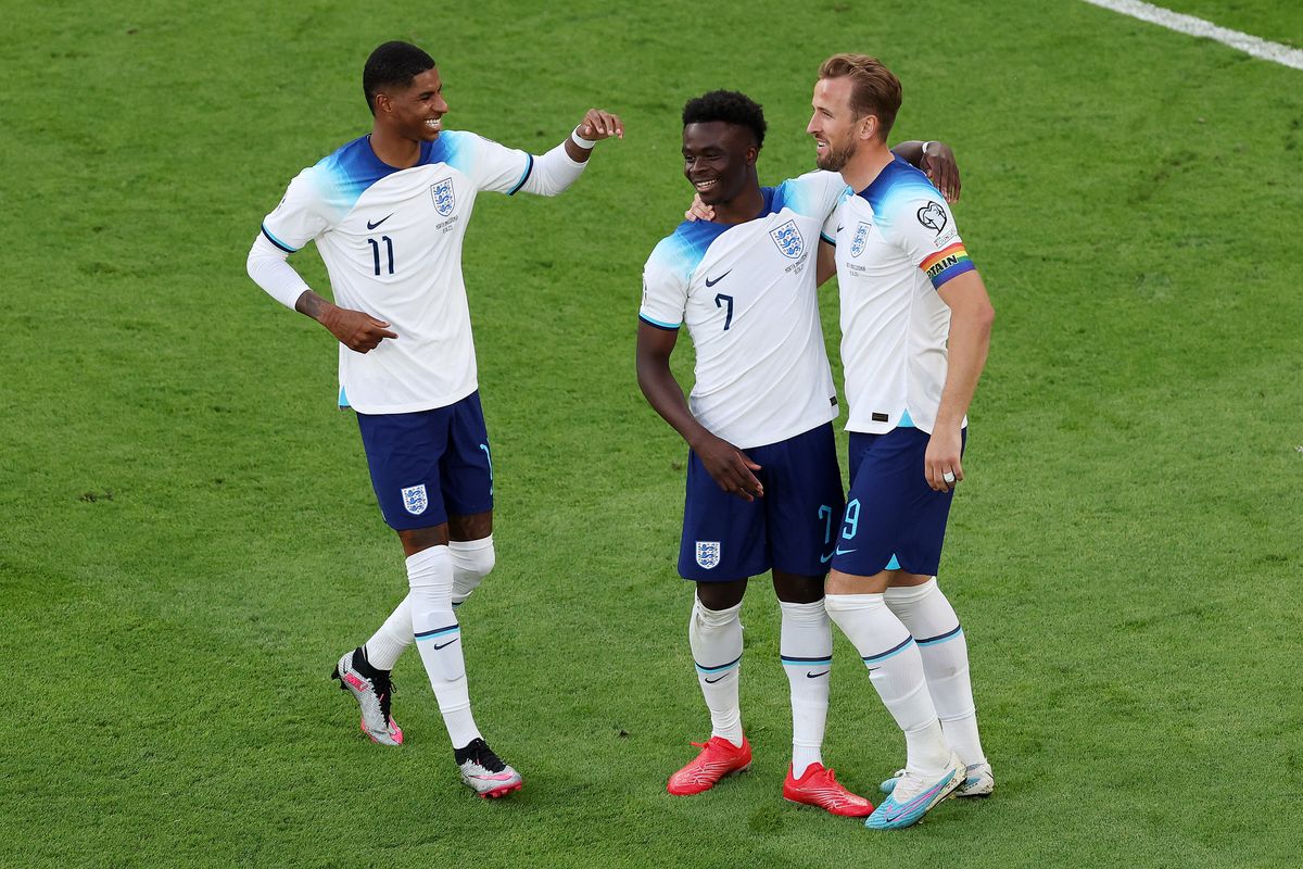 Bukayo Saka of England celebrates with teammates Marcus Rashford and Harry Kane after scoring the team's fourth goal during the UEFA EURO 2024 qualifying round group C match between England and North Macedonia at Old Trafford on June 19, 2023 in Manchester, England.
