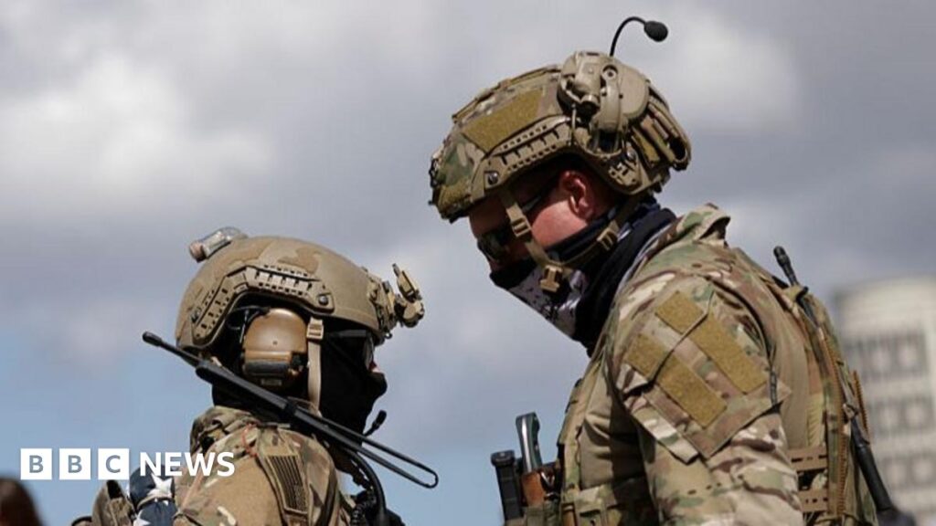 US to send 5,000 more troops to Poland, Trump says Two US military personnel dressed in camouflage