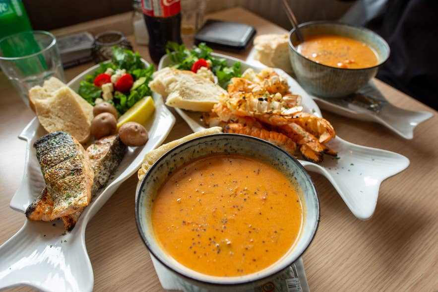 Soup with bread, grilled seafood, salad, and langoustine in Hofn, a must-try dish when vacationing on Iceland's South Coast. Soup with bread, grilled seafood, salad, and langoustine in Hofn, a must-try dish when vacationing on Iceland's South Coast.