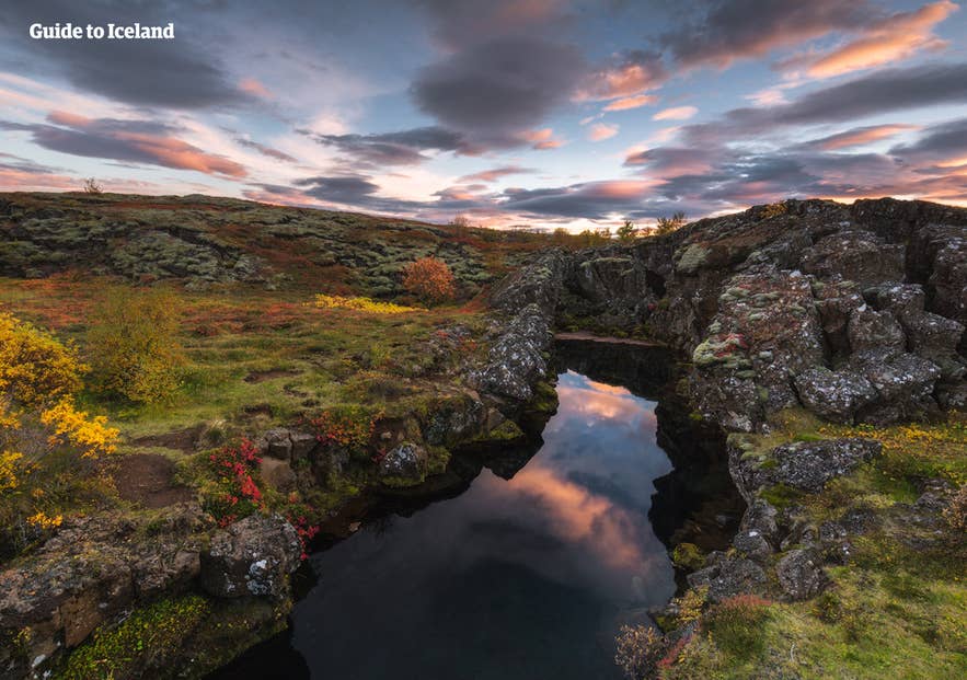 Colorful autumn reflections in a rocky spring at Thingvellir National Park under dramatic skies in Iceland. Colorful autumn reflections in a rocky spring at Thingvellir National Park under dramatic skies in Iceland.