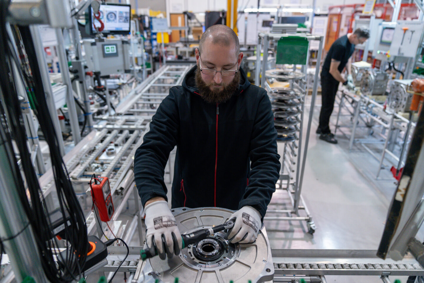 A workman assembling an AEM rare earth-free motor in a factory