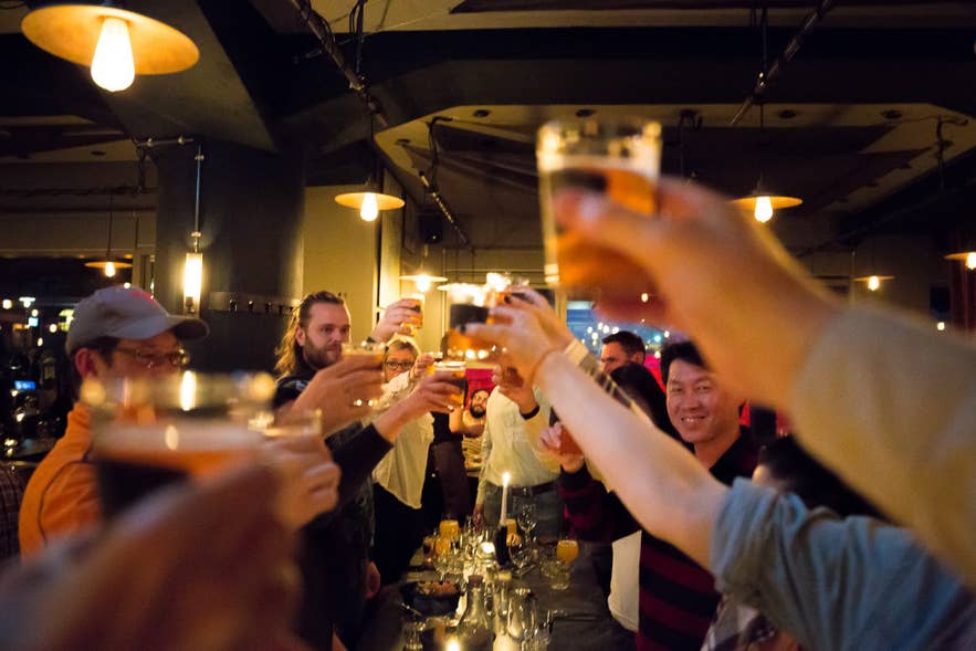 Icelanders raising glasses in a Reykjavik bar, celebrating with friends during Iceland’s vibrant nightlife. Icelanders raising glasses in a Reykjavik bar, celebrating with friends during Iceland’s vibrant nightlife.