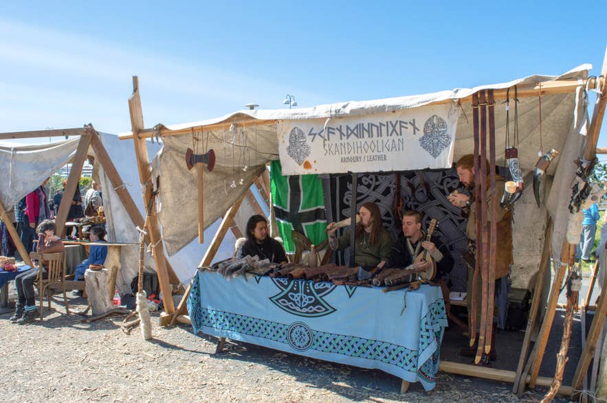Icelanders dressed as Vikings selling handcrafted leather goods and armory at a historical market in Iceland. Icelanders dressed as Vikings selling handcrafted leather goods and armory at a historical market in Iceland.