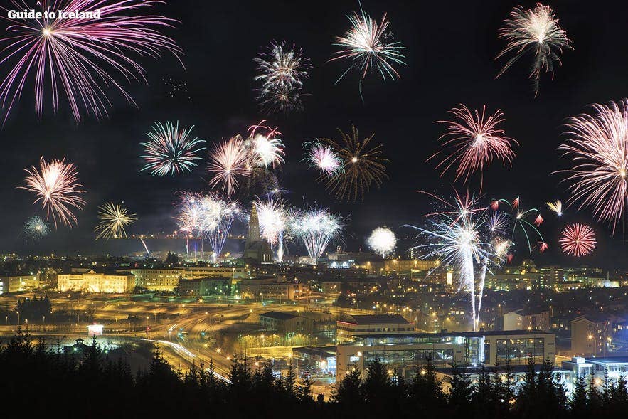 Icelanders celebrating New Year’s Eve with fireworks lighting up the night sky over Reykjavik. Icelanders celebrating New Year’s Eve with fireworks lighting up the night sky over Reykjavik.
