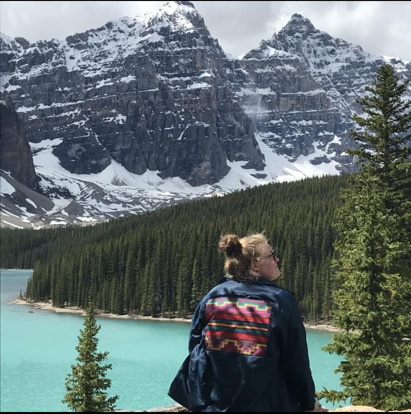 It’s been 6 years since this photo was taken of me. I still instantly recognize these peaks over Lake Moraine. I can still smell the pines and feel the crisp air. I even still have the vintage windbreaker tucked away in my closet.
