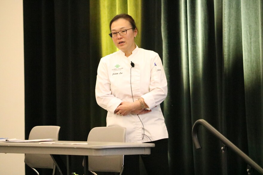 A person in a white chef's coat. 