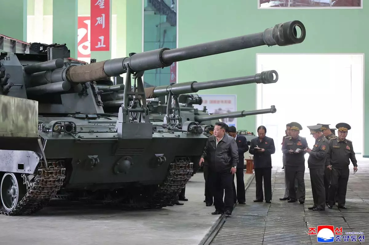 In this photo provided on May 8, 2026, by the North Korean government, its leader Kim Jong Un, center, visits a major munitions factory at an undisclosed location, North Korea Wednesday, May 6, 2026. Independent journalists were not given access to cover the event depicted in this image distributed by the North Korean government. The content of this image is as provided and cannot be independently verified. Korean language watermark on image as provided by source reads: "KCNA" which is the abbreviation for Korean Central News Agency. (Korean Central News Agency/Korea News Service via AP)