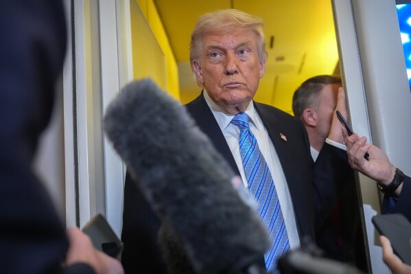 President Donald Trump speaks to reporters aboard Air Force One, May 15, 2026, as he returns from a trip to Beijing, China. (AP Photo/Mark Schiefelbein, File)