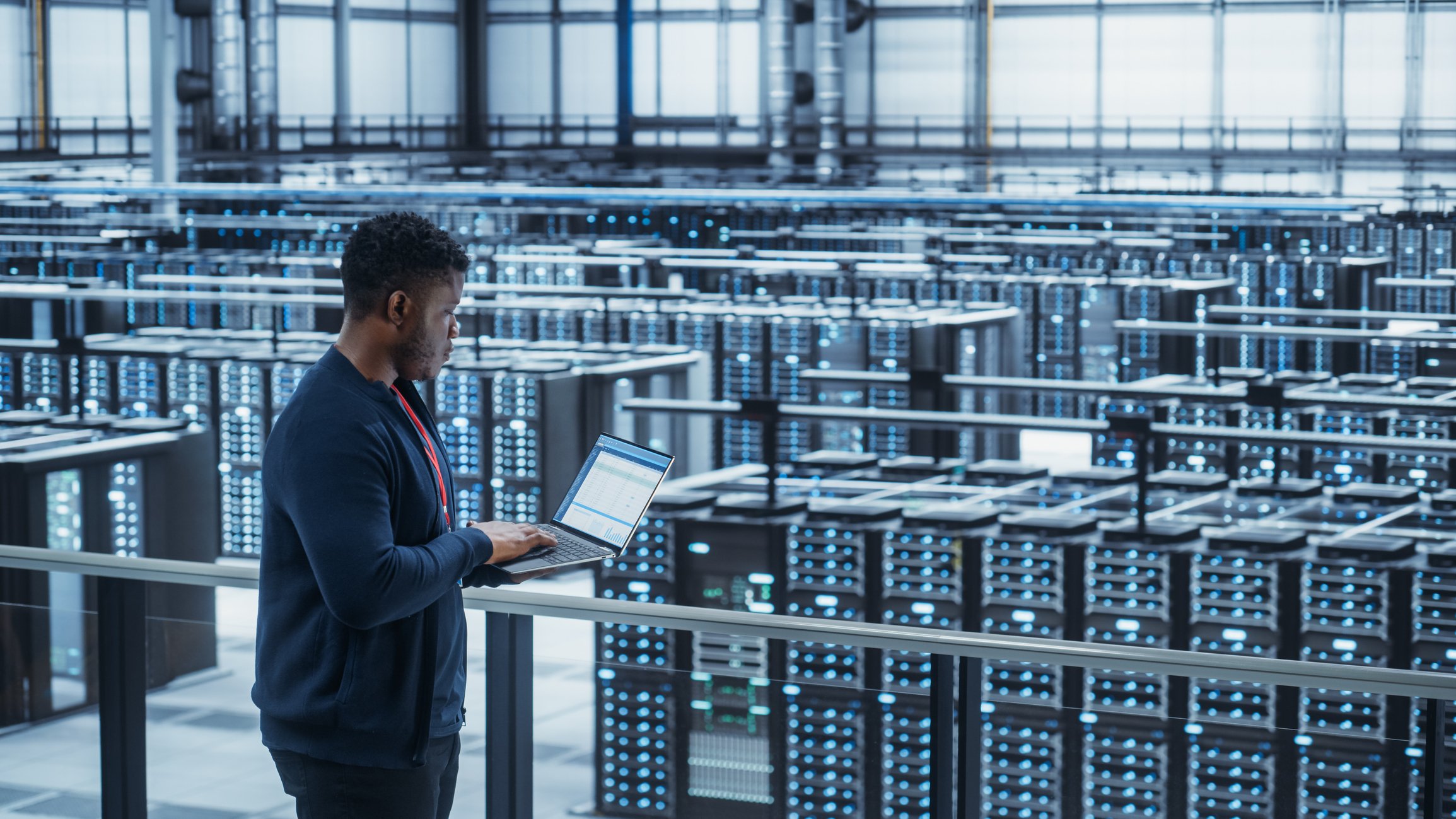A technician overlooking a data center.