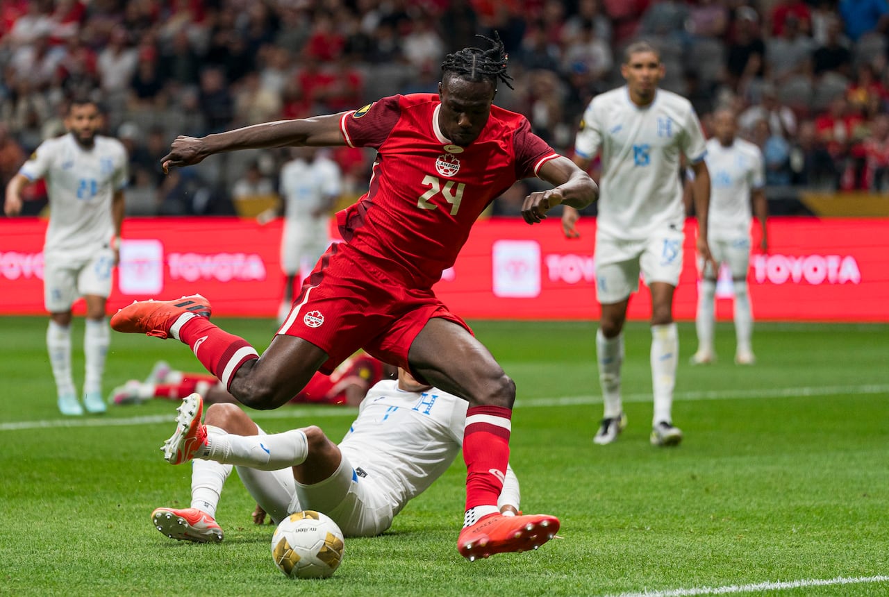 A soccer player kicks the ball.