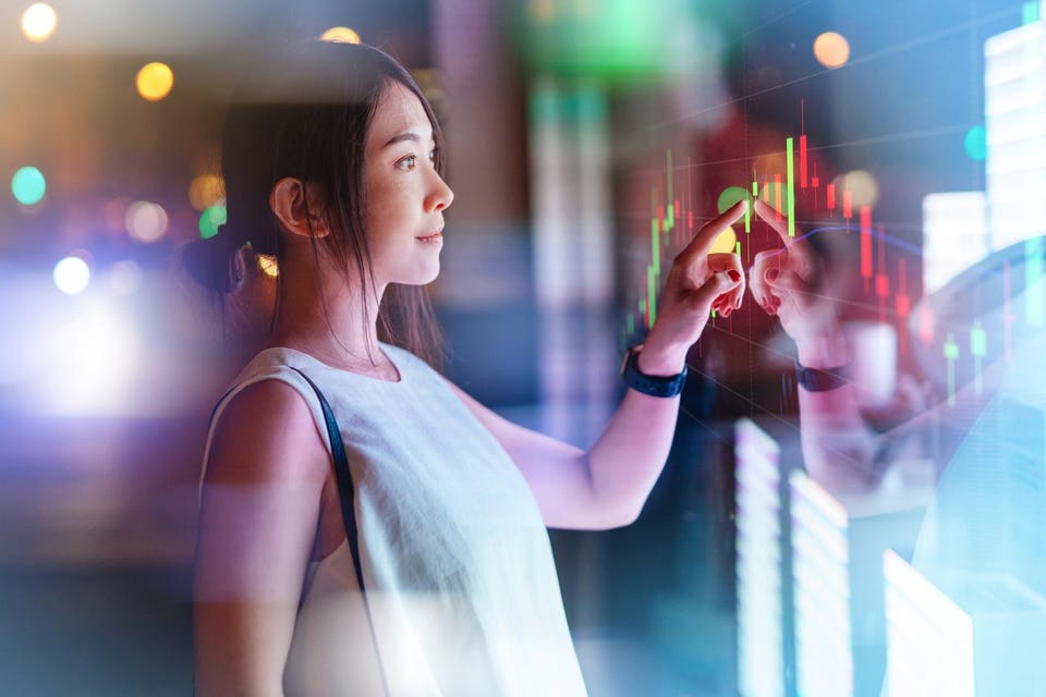Young woman touching screen on futuristic digital display.