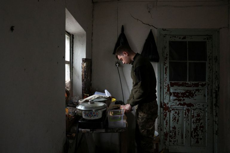 A soldier of the 59th Assault Brigade on rotation out of the eastern combat zone cooks food at a resting house during a five-day leave in the rear of the frontlines at an undisclosed location in the Dnipropetrovsk region before returning to the Pokrovsk defence effort, amid Russia's attack on Ukraine, Ukraine April 1, 2025. REUTERS/Violeta Santos Moura