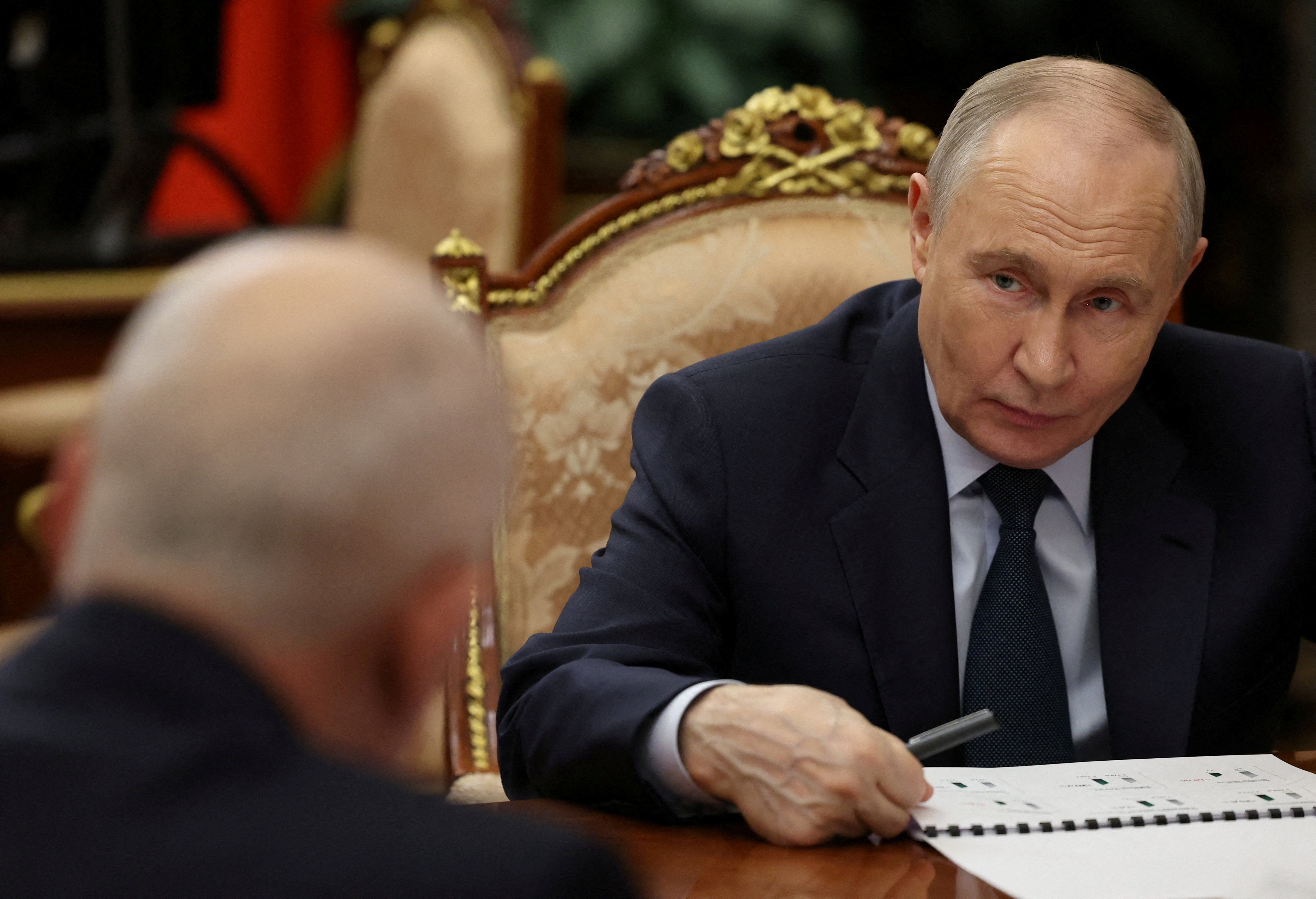 Russia's president Vladimir Putin attends a meeting with CEO of Rostec state corporation Sergei Chemezov in Moscow