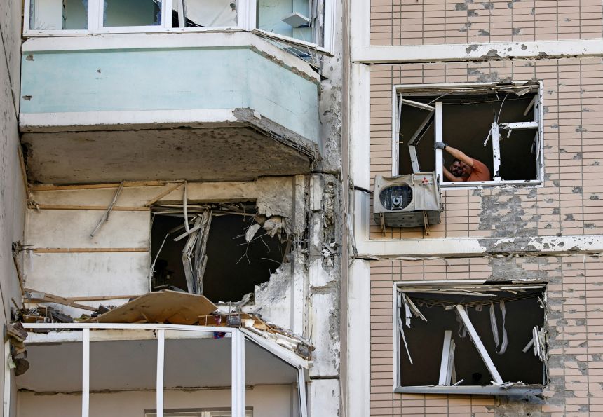 Residents clear broken windows in a damaged apartment building following a Ukrainian drone attack in Krasnogorsk, in Russia's Moscow region on May 17. REUTERS/Stringer TPX IMAGES OF THE DAY