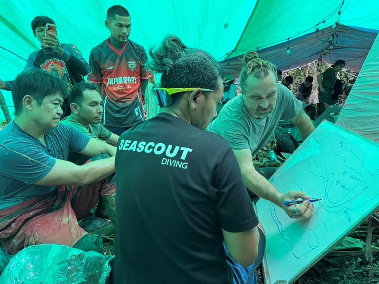 Rescue workers gather to discuss plans to rescue people trapped in a cave in Xaisomboun Province, Laos, in this handout image released on May 29, 2026.