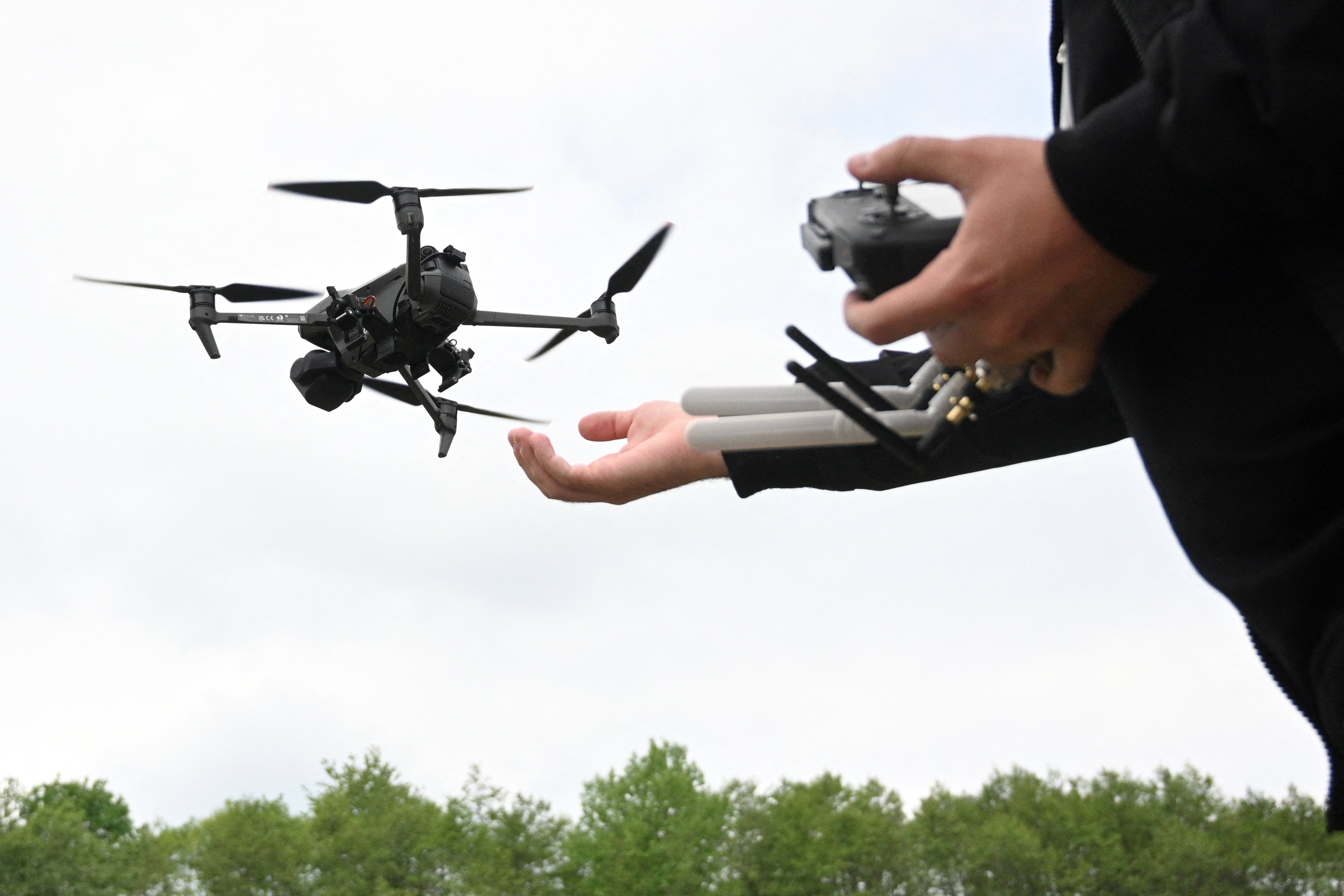 A man pilots a drone during the Wild Drones racing competition in Truskavets in the Lviv region of Ukraine