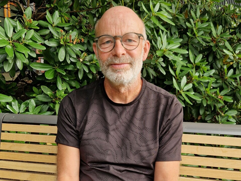 Portrait photo of man sitting outdoors.