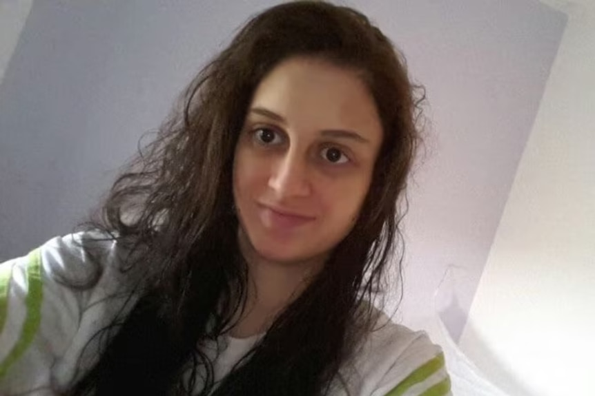 A teenage girl with long, dark hair.