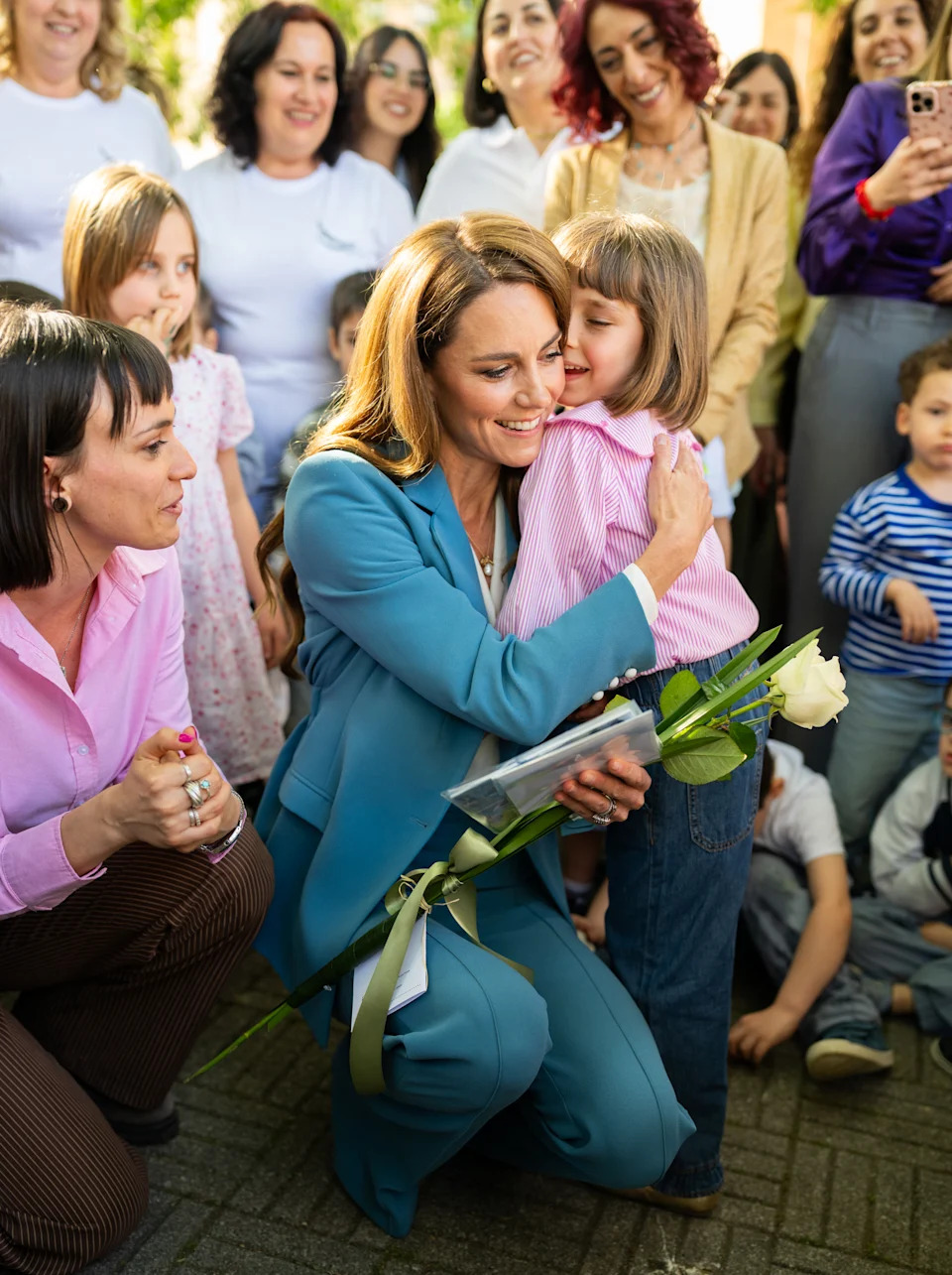 REGGIO EMILIA, ITALY - MAY 13: Catherine, Princess of Wales hugs a child as she visits Scuola Comunale d'infanzia Anna Frank, a municipal pre-school for 3 – 6-year-olds  during the first day of her visit to Reggio Emilia on May 13, 2026 in Reggio Emilia, Italy. The Princess of Wales is visiting the city in Northern Italy as The Royal Foundation Centre for Early Childhood expands internationally. During her visit, she will explore leading approaches to early child development, which focusses on creativity, relationships and hands-on discovery. The trip marks the future queen's first overseas royal visit since her cancer treatment. (Photo by Samir Hussein - Pool/Getty Images)
