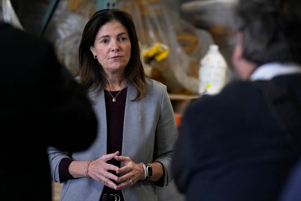 N.H. Governor Kelly Ayotte speaks with Manchester businessmen in October 2024.