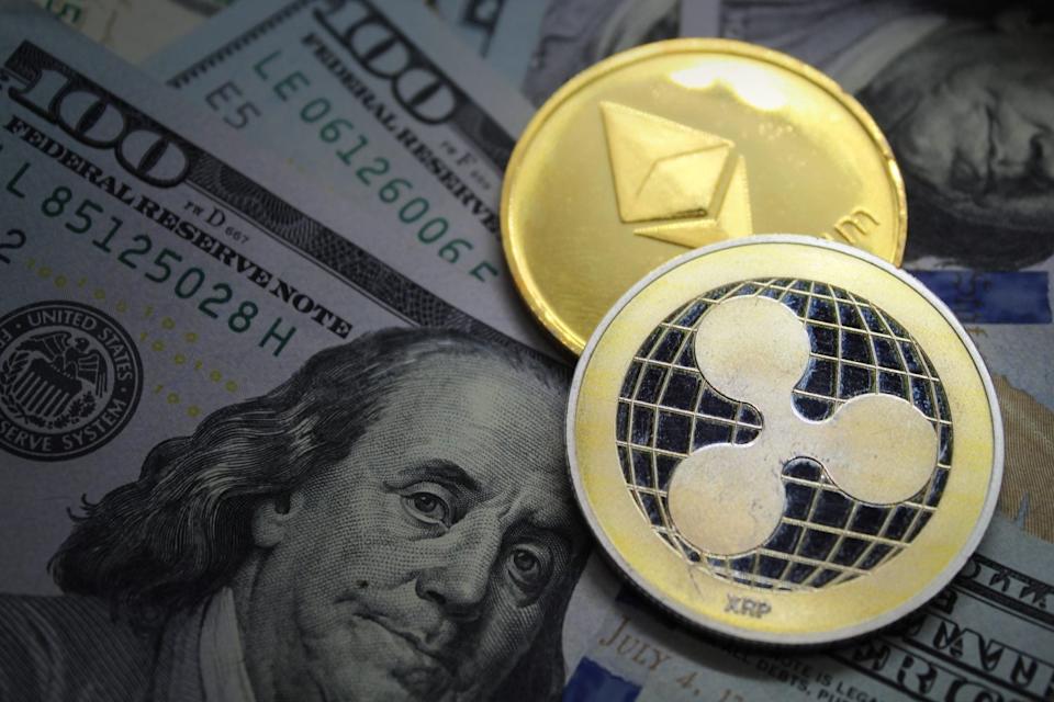 Crypto Coins XRP Ripple and ETH Ethereum on US Dollar bills