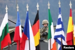 A Romanian soldier of the EUFOR (European Union Forces in Bosnia and Herzegovina) stands guard in Sarajevo in April 2025.