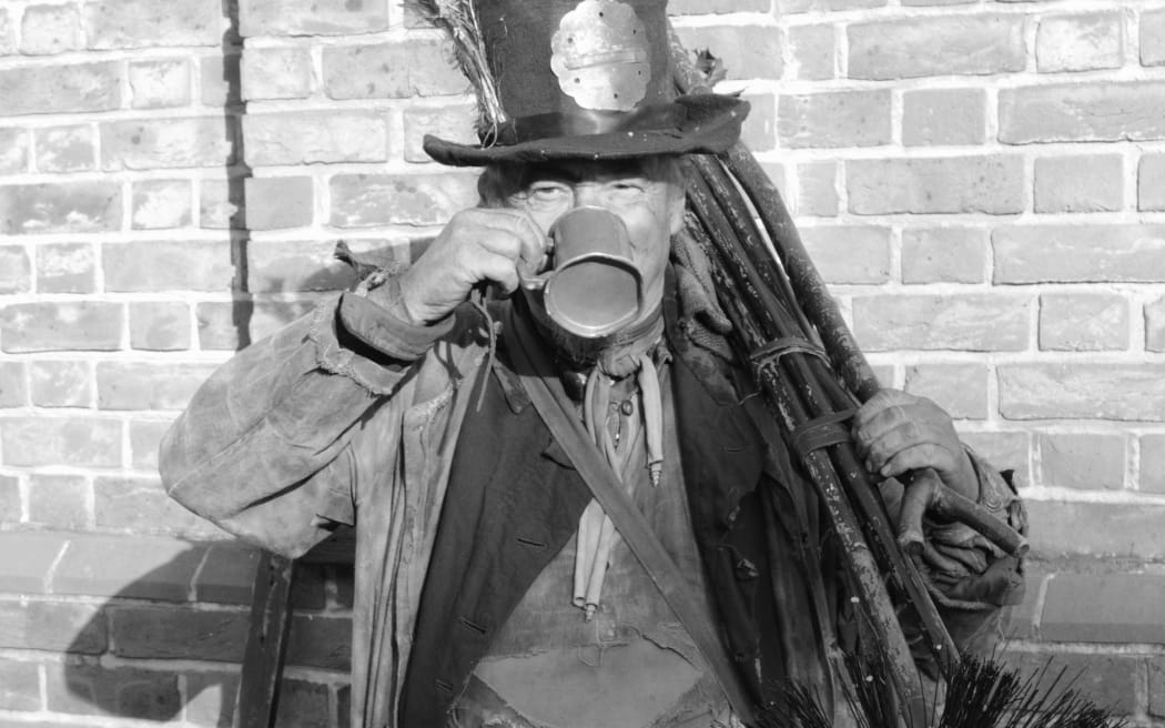 17435964 - victorian chimney sweep wearing his old clothes & carrying his brush
