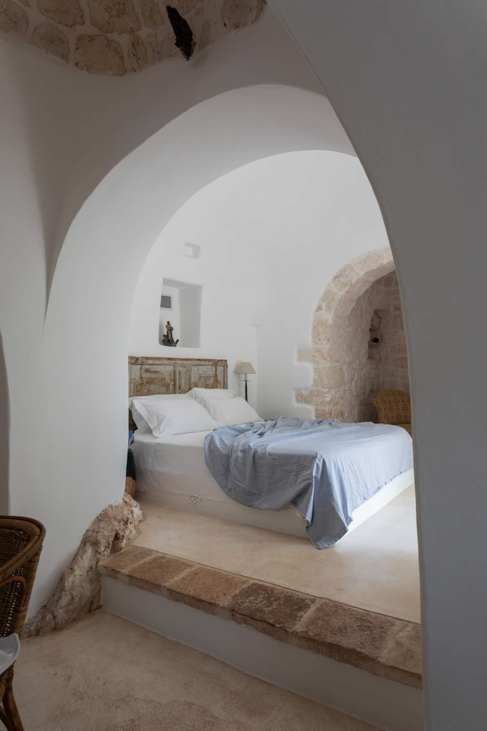 Image may contain Bed Furniture Arch Architecture Home Decor Lamp Indoors Interior Design Person Bedroom and Room