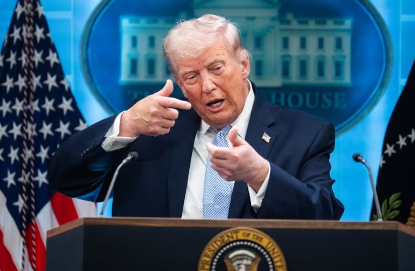 President Donald Trump mimics firing a gun during a news conference in the White House briefing room about the war in Iran on Monday, April 6, 2026. 