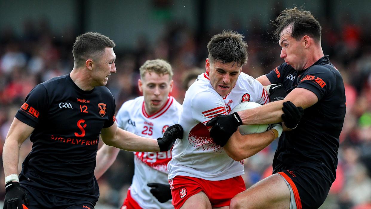 Conor Doherty and Barry McCambridge compete for the ball