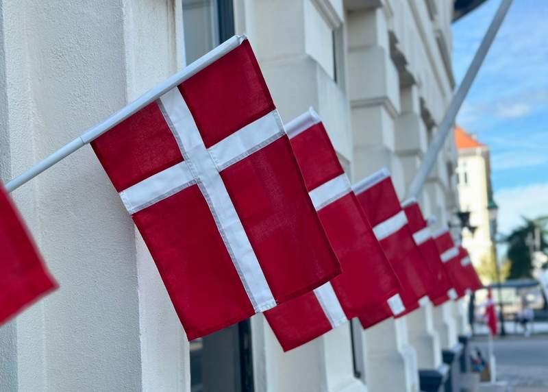 FILE PHOTO - Danish flags hang from a store near Nyhavn, the popular tourist harbor in the center of Copenhagen. (is associated with: «Denmark consumer confidence weakens to 6-month low») Steffen Trumpf/dpa